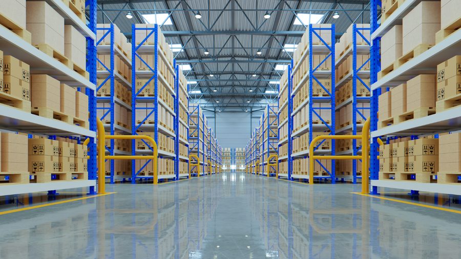 Racked distribution warehouse aisle under high-bay lighting